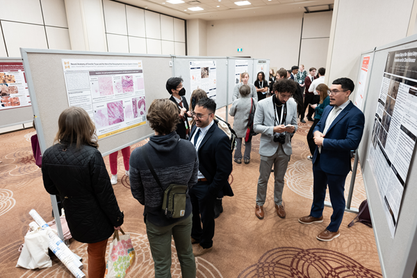 large group of people exploring poster presentations at Anatomy Connected 2024 in Toronto